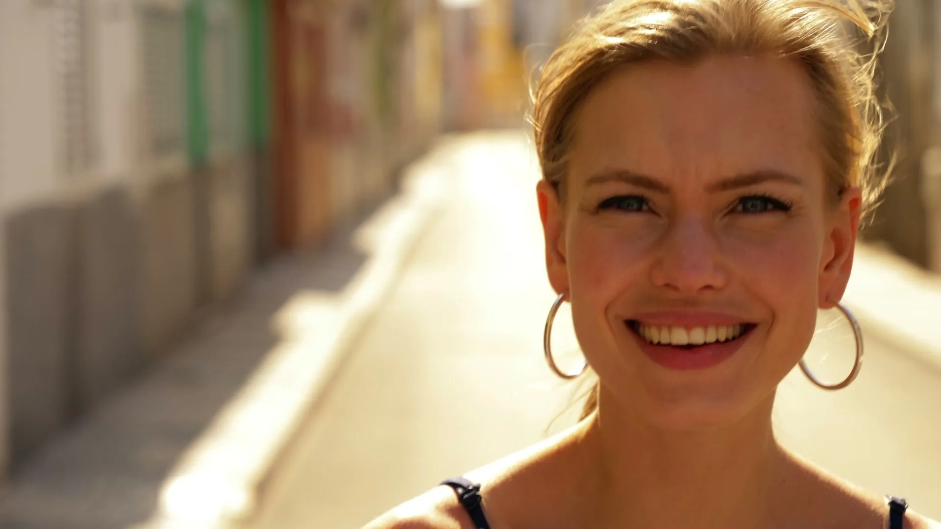 A woman smiling in an urban setting