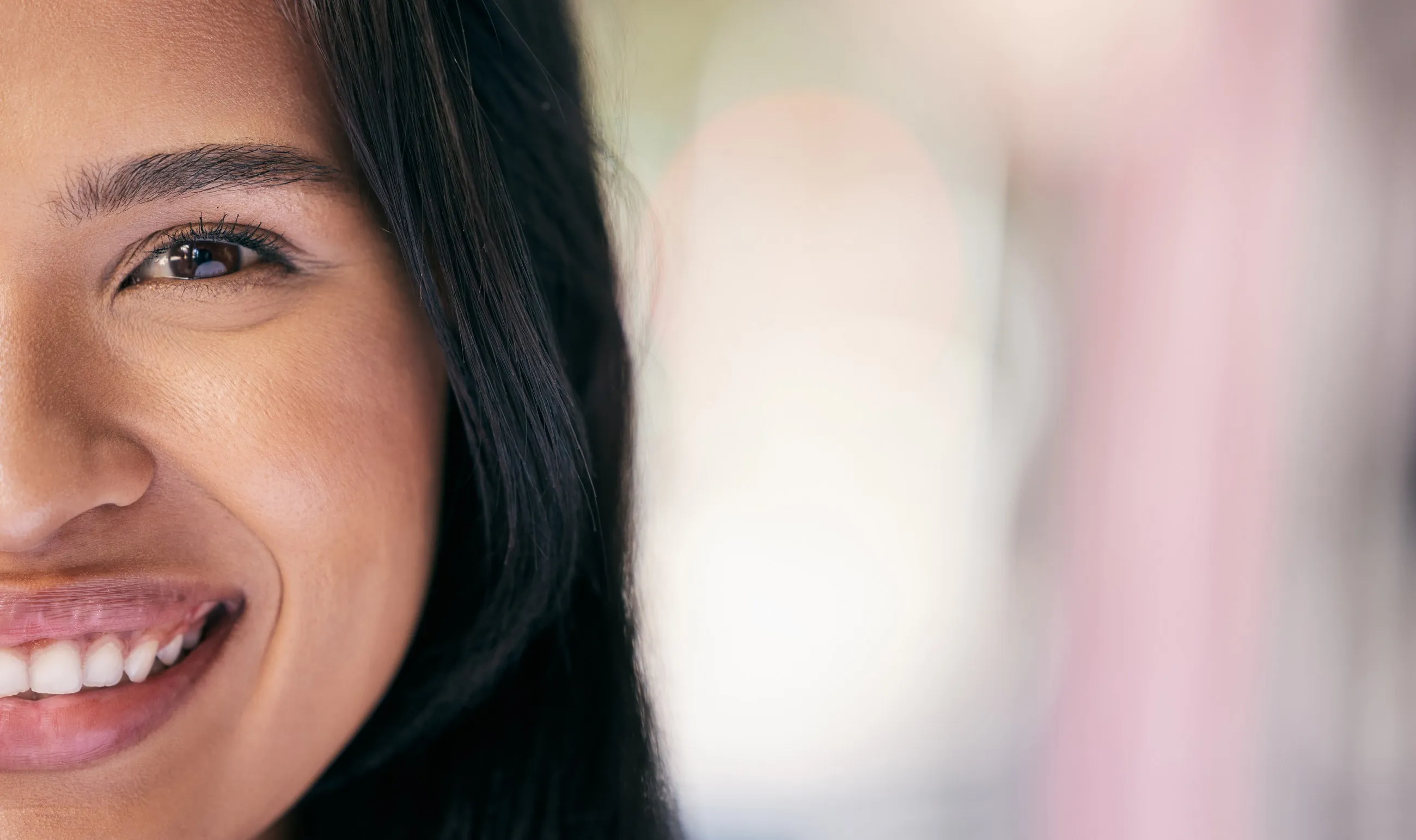 A brunette woman smiling, close up