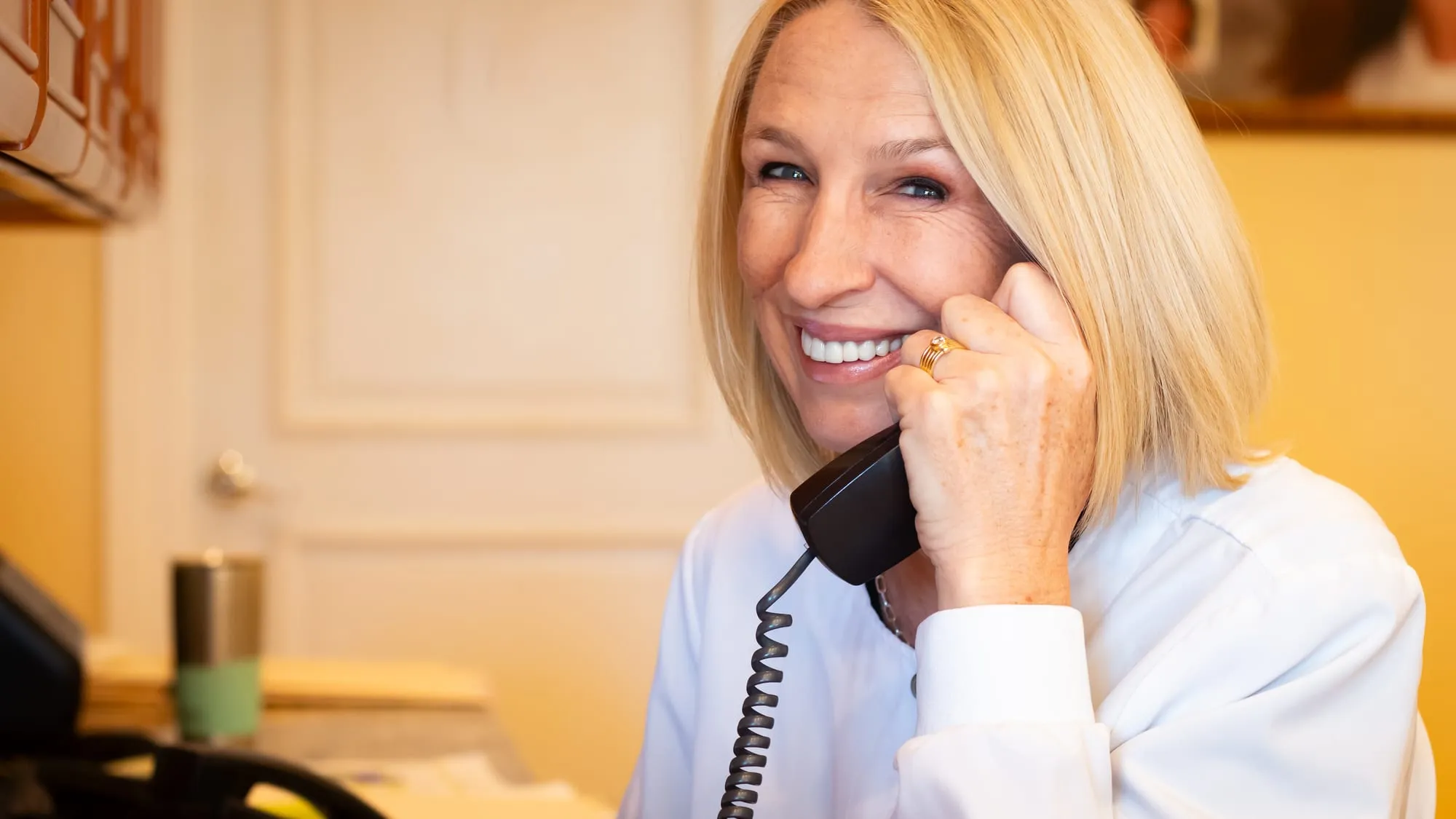A clinician on the phone at Sarasota Smile Design in Sarasota, Florida