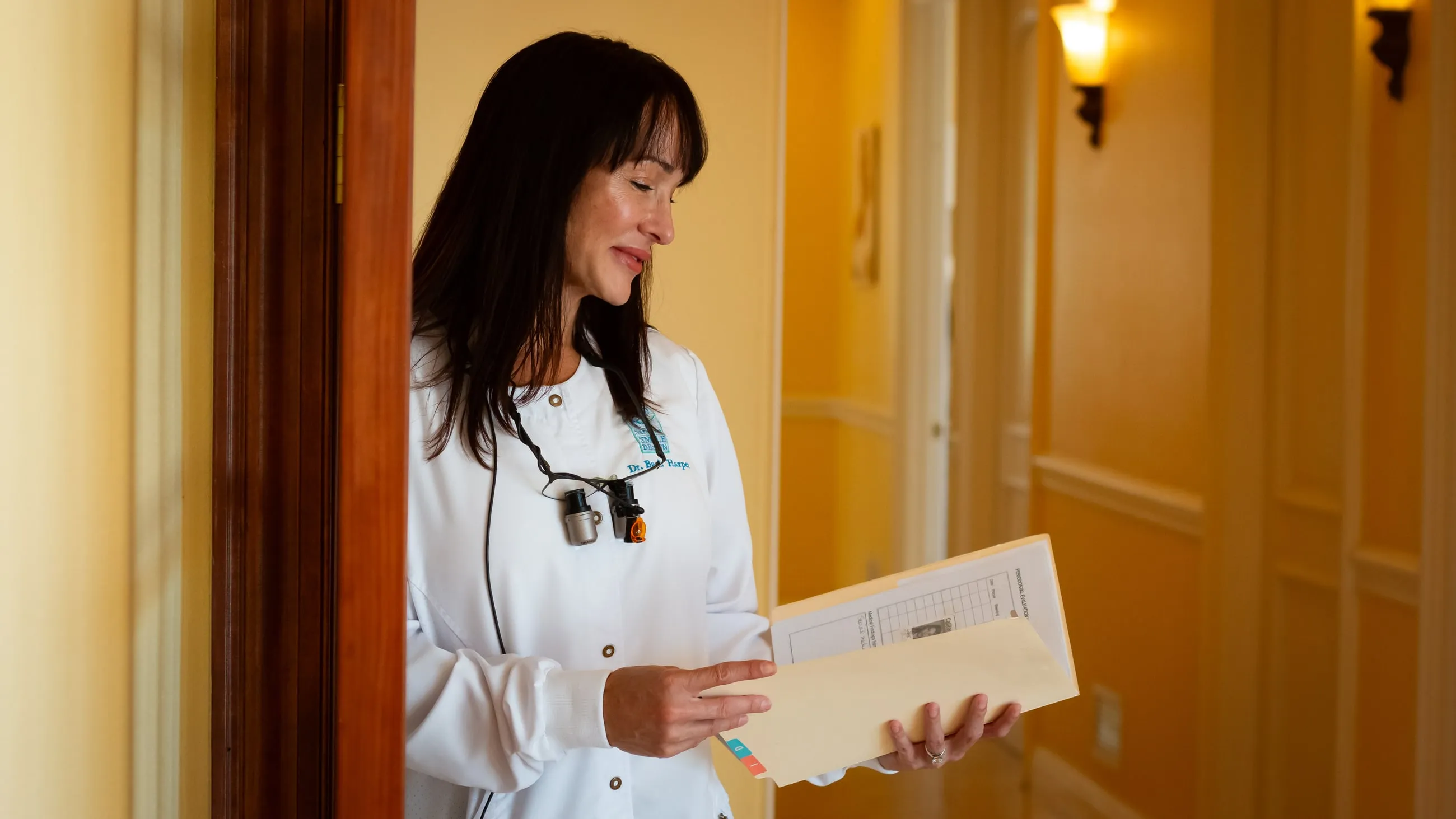 Dr. Jenifer Back reviewing a chart at Sarasota Smile Design in Sarasota, Florida