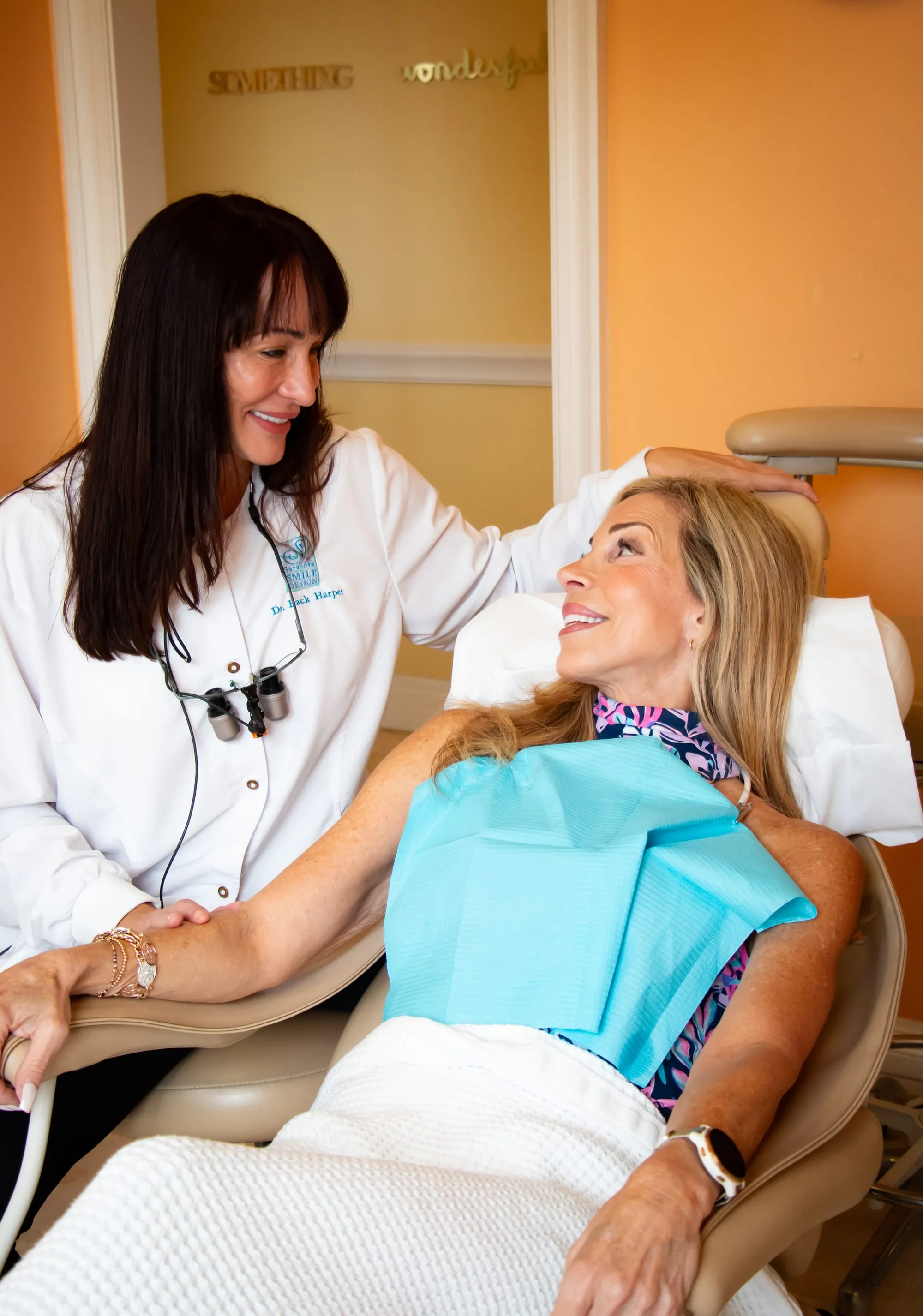 Dr. Jenifer Back laughing with a patient at Sarasota Smile Design in Sarasota, Florida