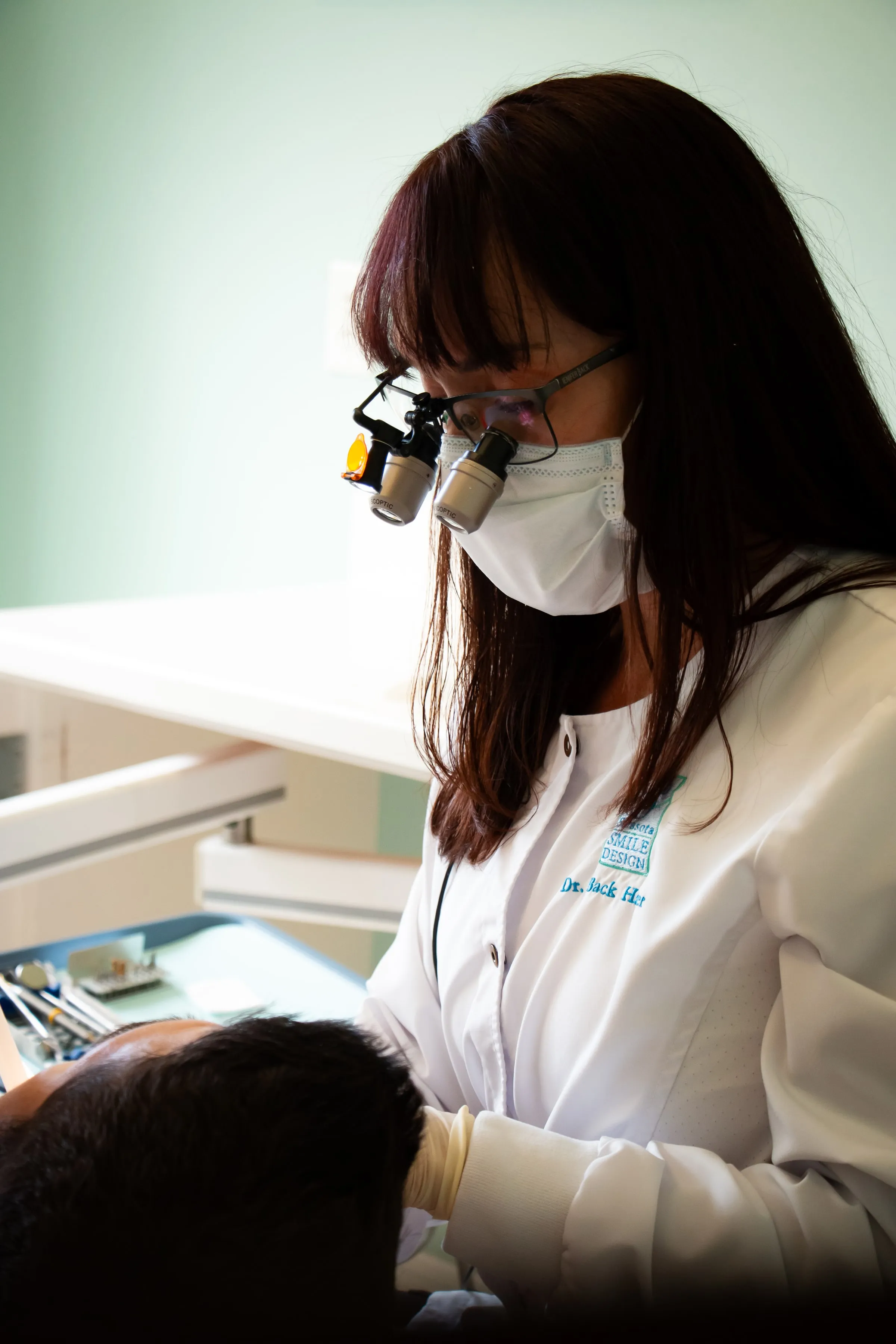 Dr. Jenifer Back with loupes raised at Sarasota Smile Design in Sarasota, Florida
