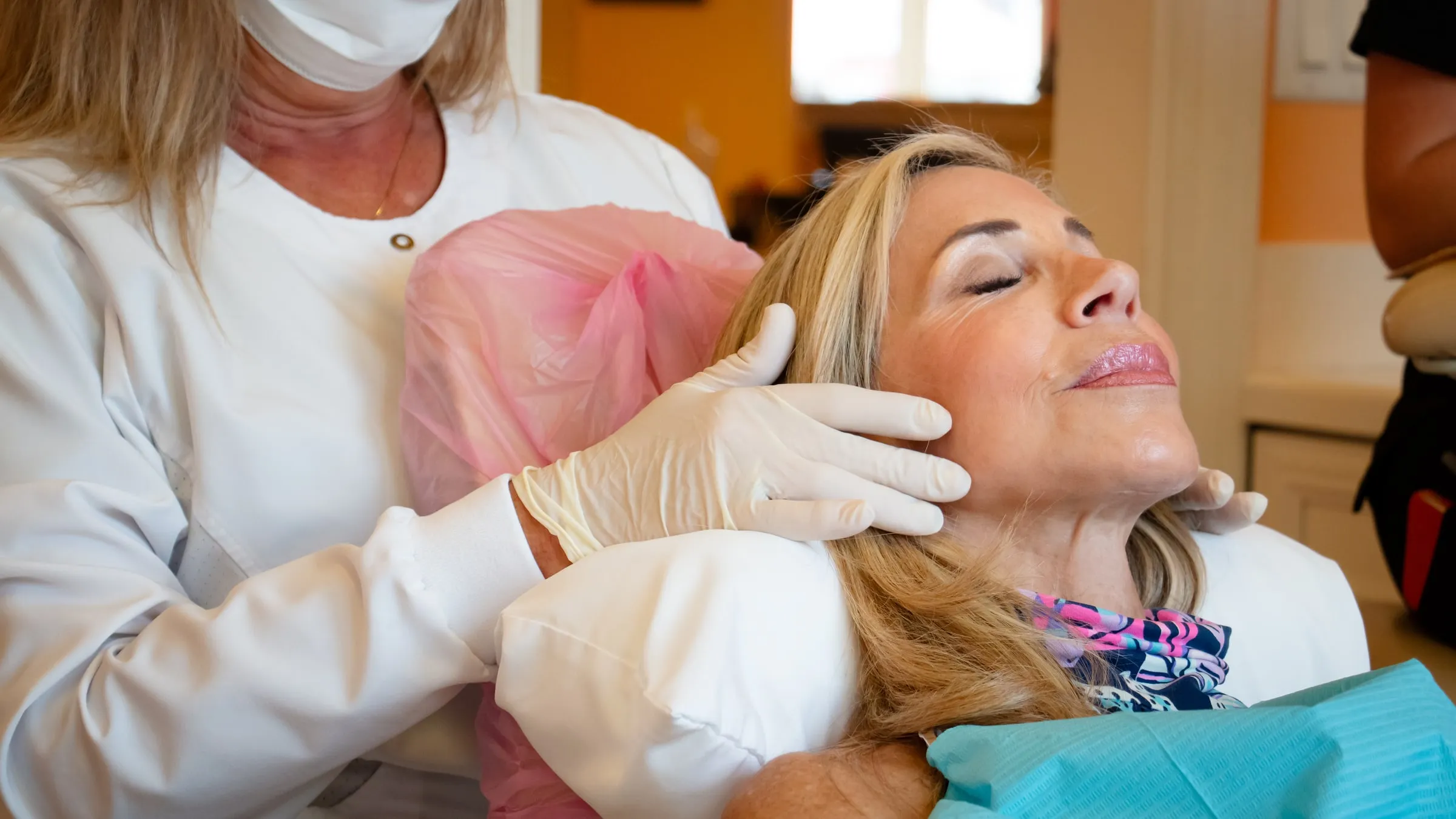 A patient resting with her eyes closed during treatment at Sarasota Smile Design in Sarasota, Florida
