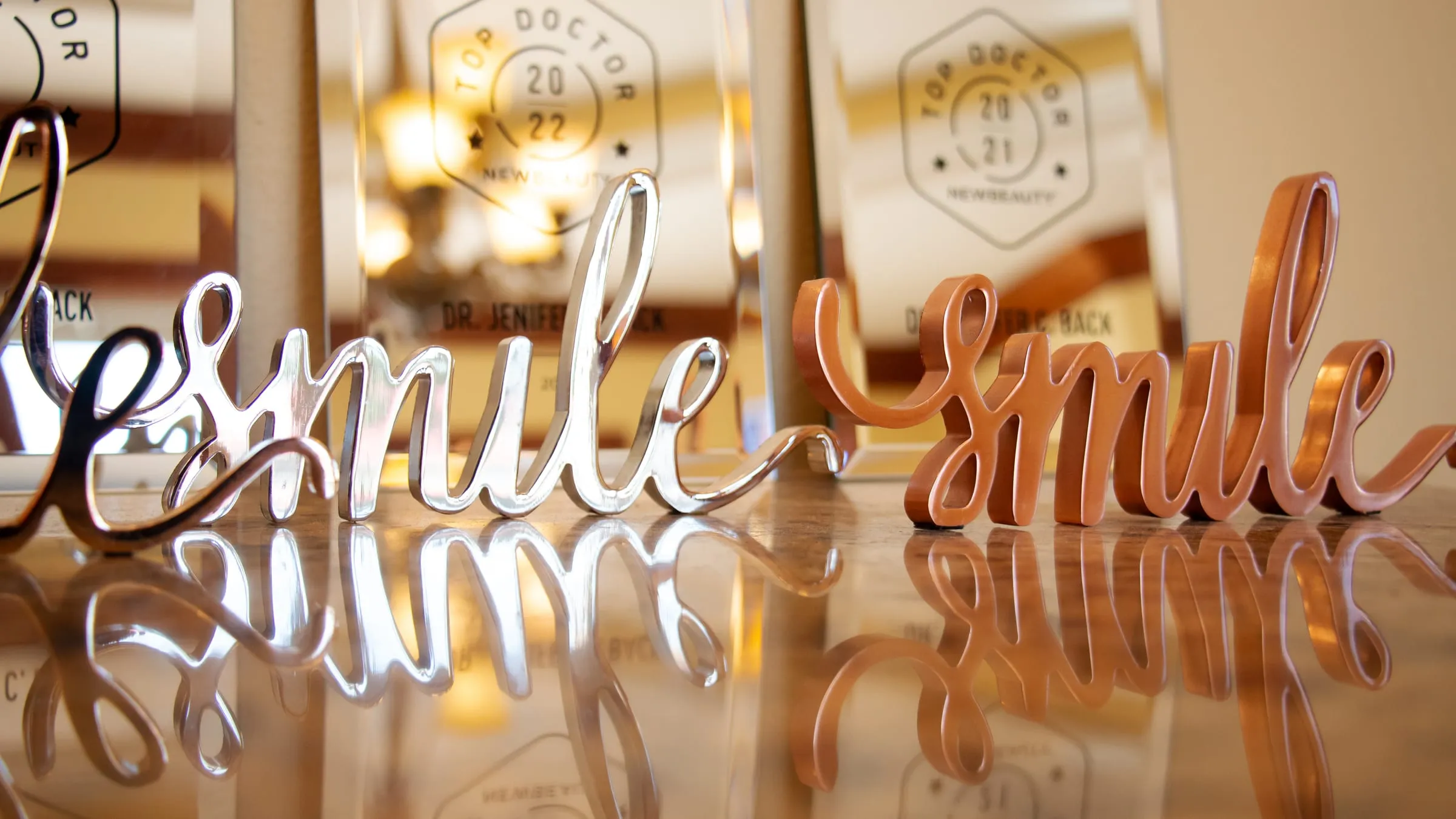 Script lettering reading smile on the wall at Sarasota Smile Design in Sarasota, Florida