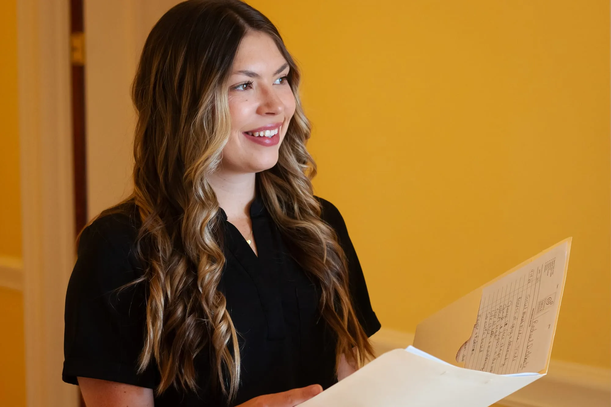 A member of staff reviewing a chart at Sarasota Smile Design in Sarasota, Florida