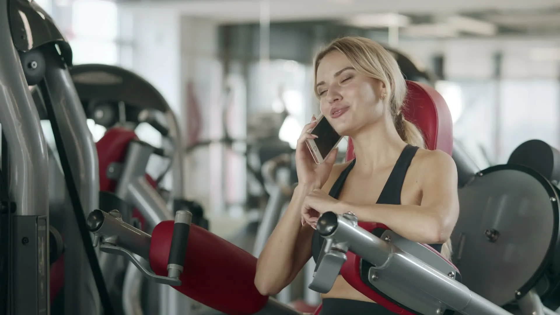 A smiling woman at a modern gym