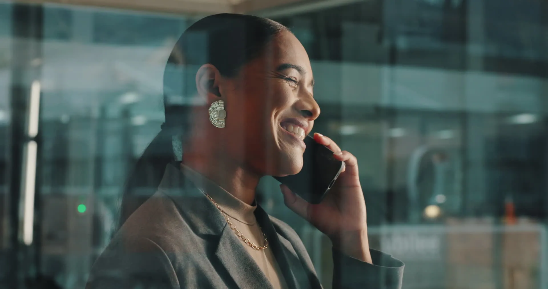A smiling woman on the phone in a bright office