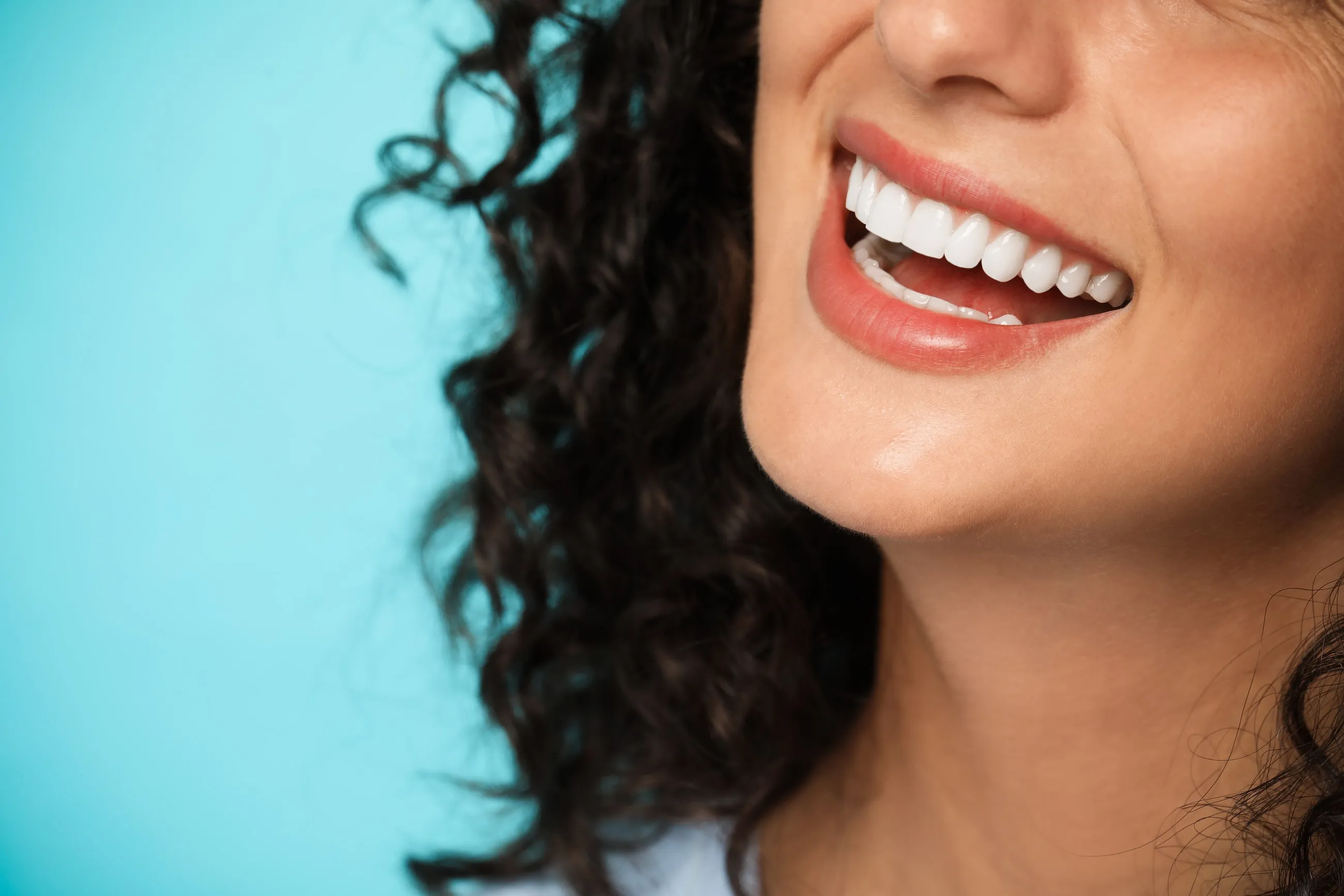 A woman smiling with white teeth, close up