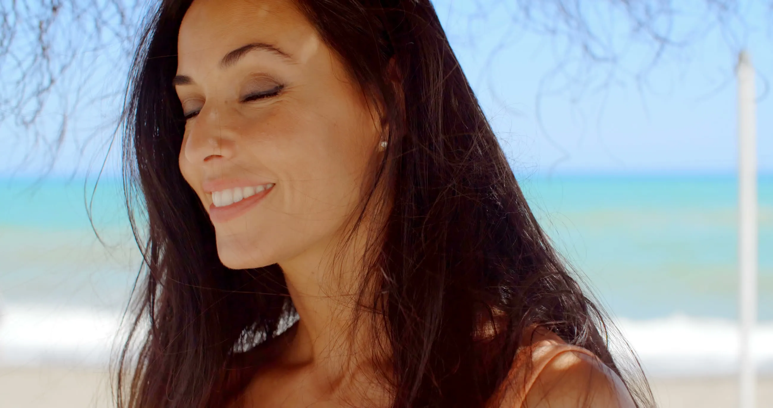 A woman smiling on the beach