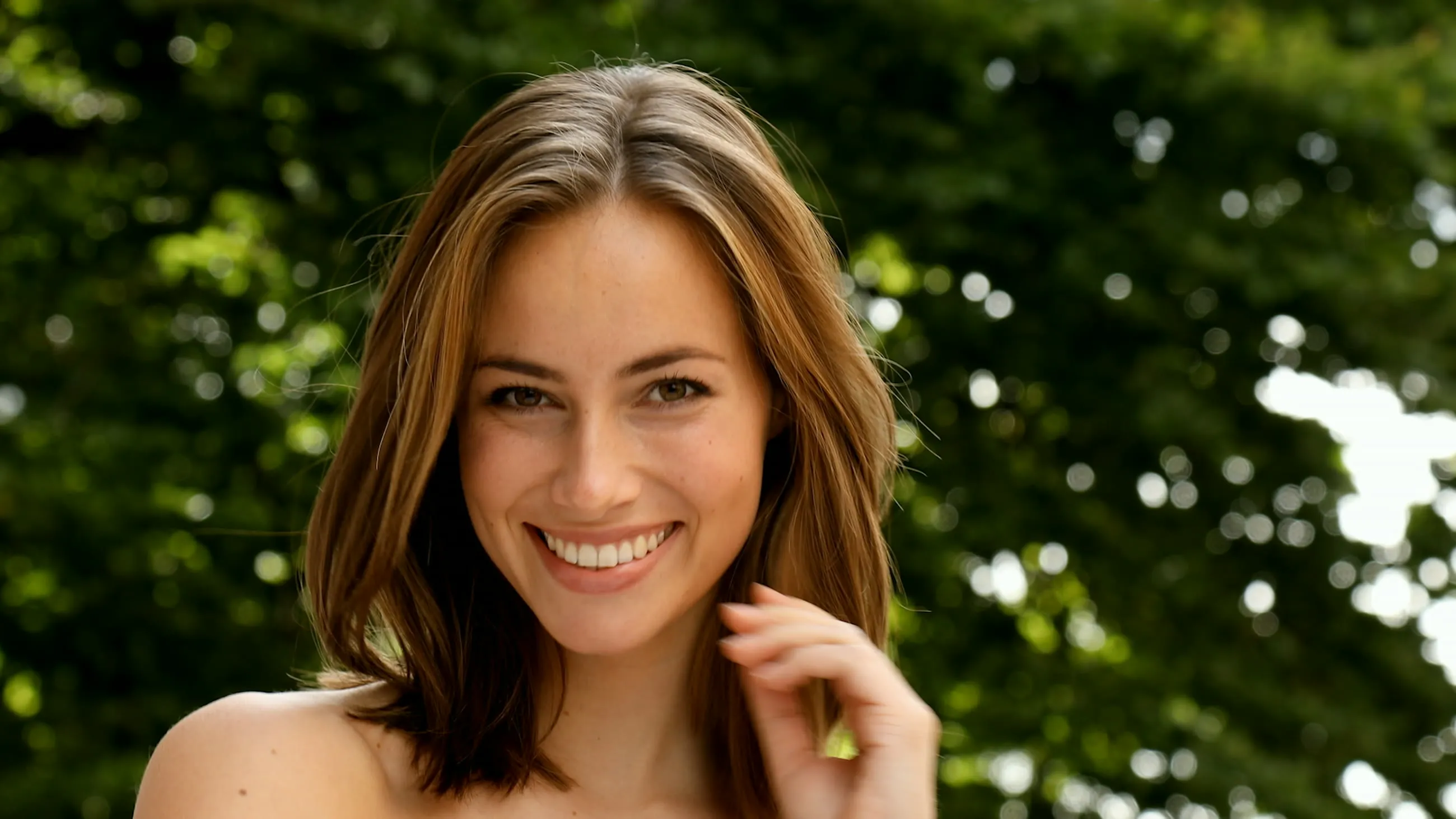 A woman smiling in a studio portrait