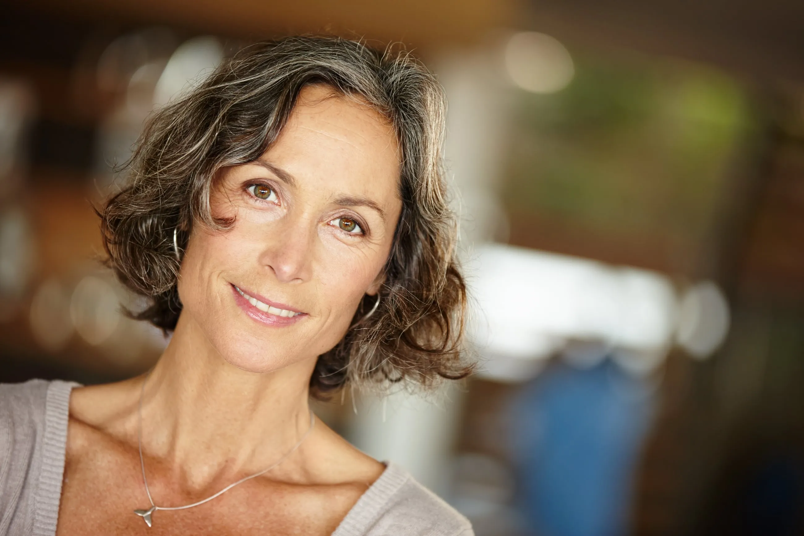 A woman smiling, photographed in natural light in Sarasota, Florida